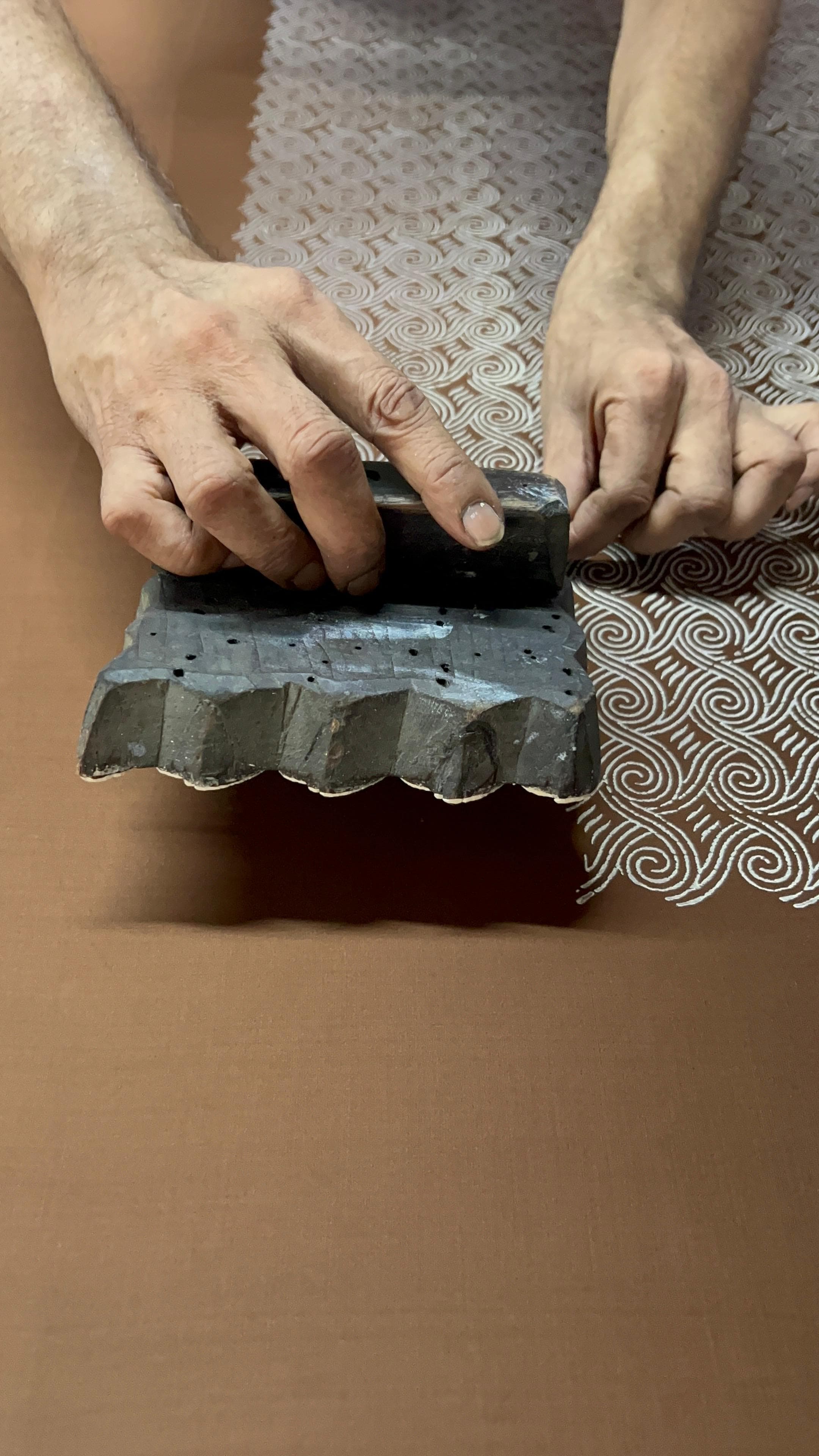 A hand-carved teak printing block used to stamp the silk